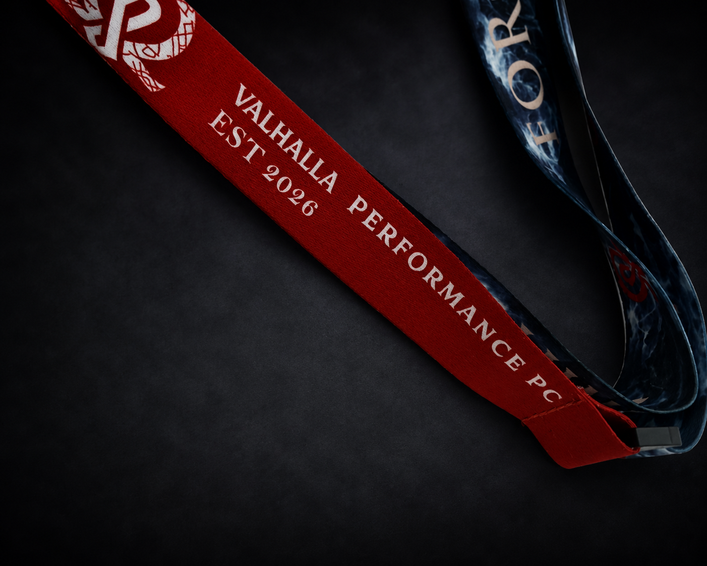 Red Valhalla Performance PC woven lanyard close-up with EST 2026 branding, showcasing Forge Your Legacy merchandise, premium textured fabric, branded gaming PC accessories, and Valhalla custom PC lifestyle gear.