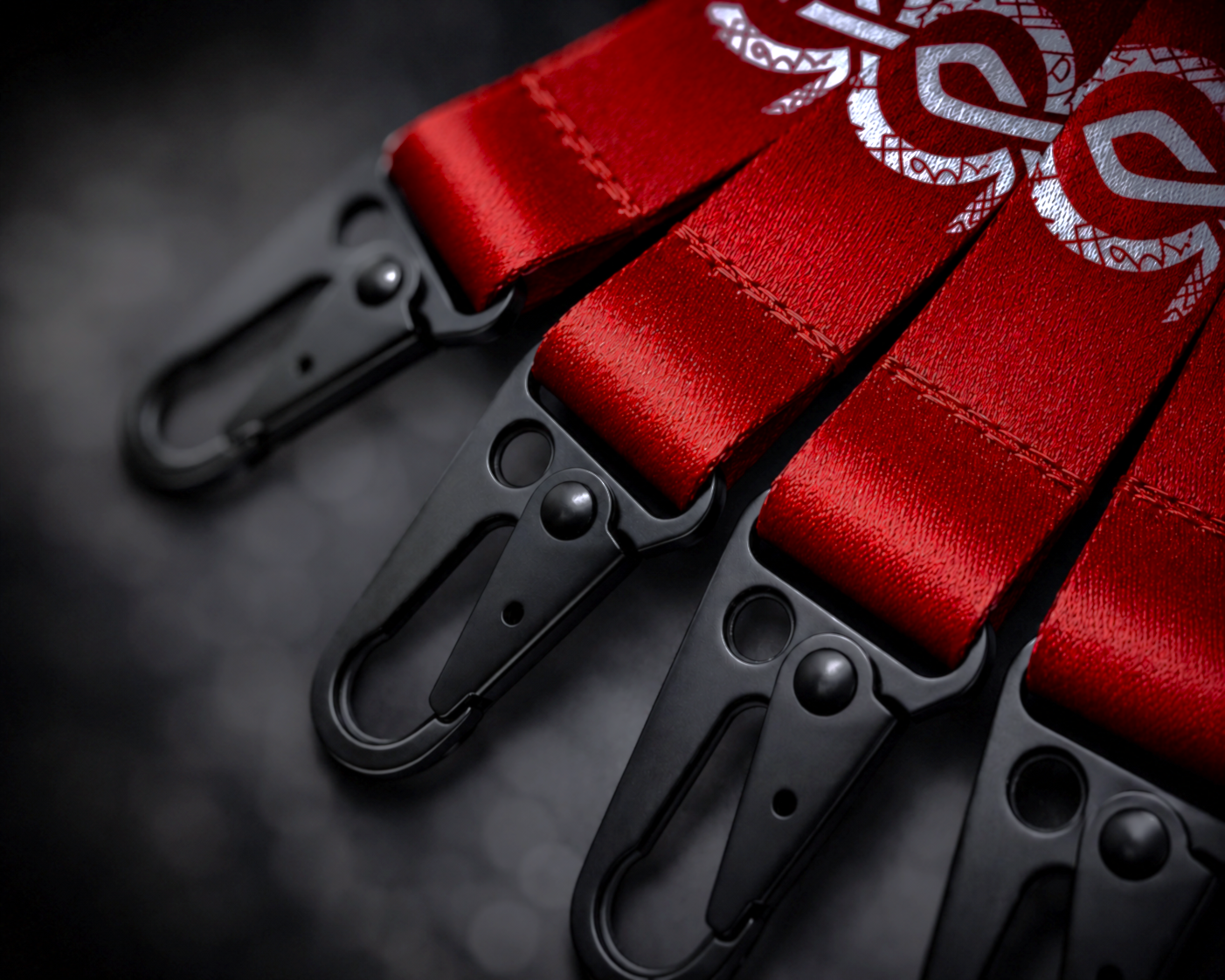 Valhalla Forge Your Legacy premium woven lanyard close-up with red fabric, black metal clasp hardware, textured strap detail, and branded custom gaming PC merchandise for Valhalla Performance PC.