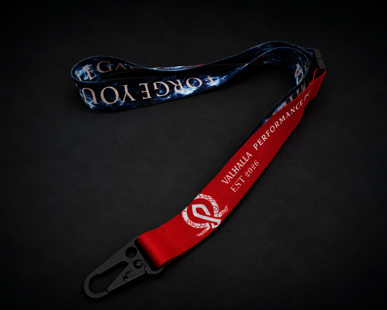 Valhalla Performance PC premium woven lanyard with red strap, storm artwork, Forge Your Legacy branding, and black metal clasp on a dark background