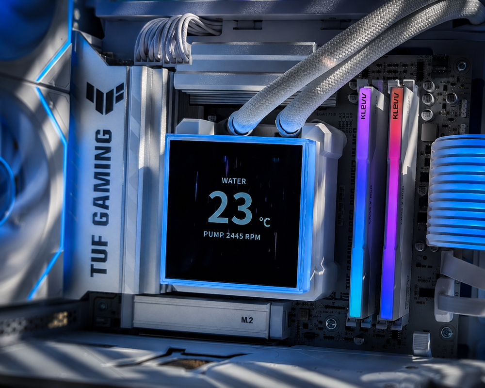 Close-up of a white HydroShift liquid-cooled gaming PC featuring an illuminated AIO display and braided coolant tubes.